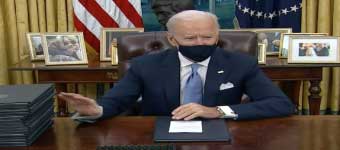 Joe Biden with Executive Orders at Desk