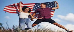 Couple Holding USA Flag Jumping and Smiling