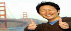 Smiling Japanese Man Giving Thumbs Up at Golden Gate Bridge